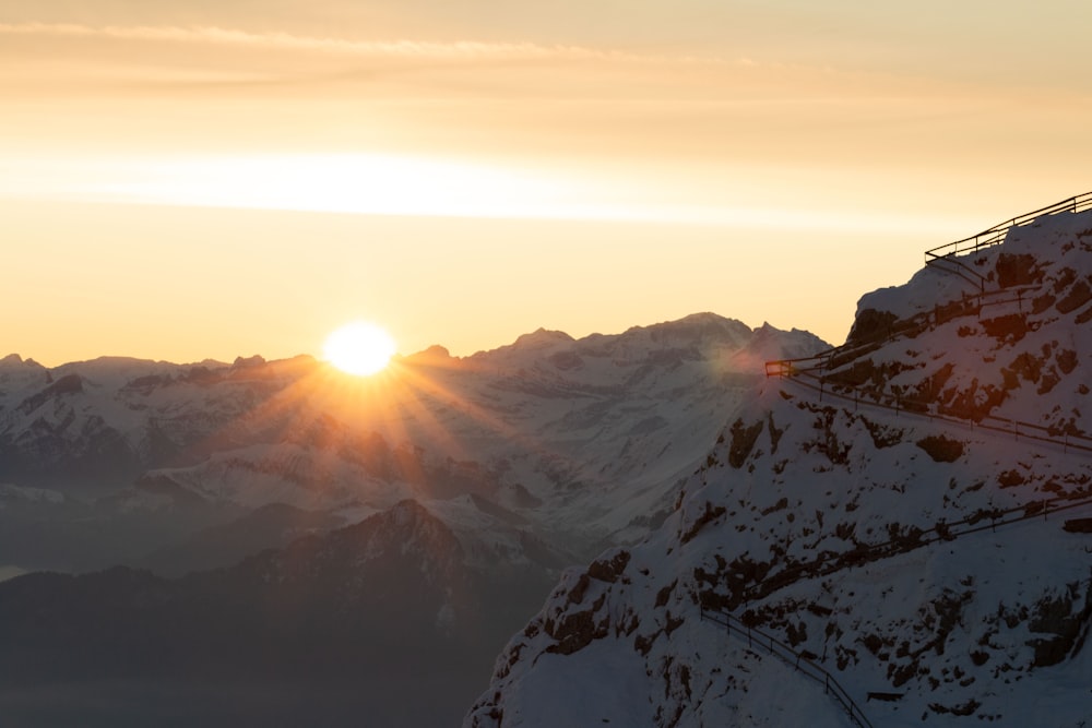 snow covered mountains during sunrise