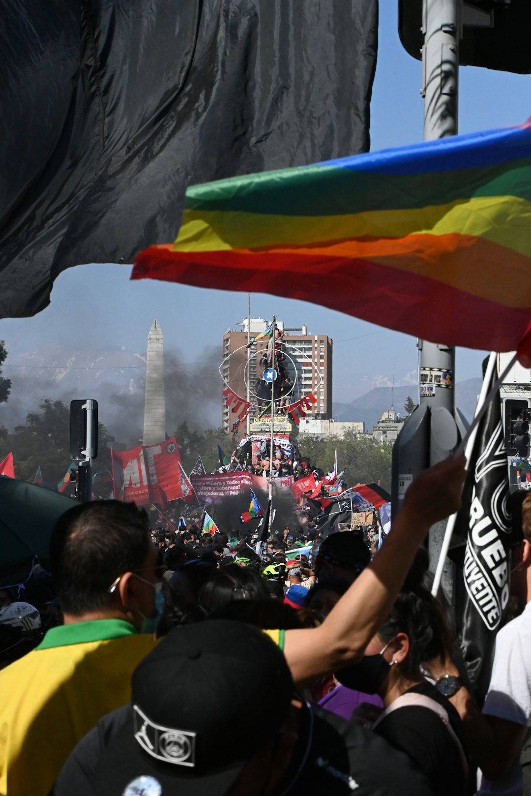 people sitting on green chairs near red and white flag during daytime