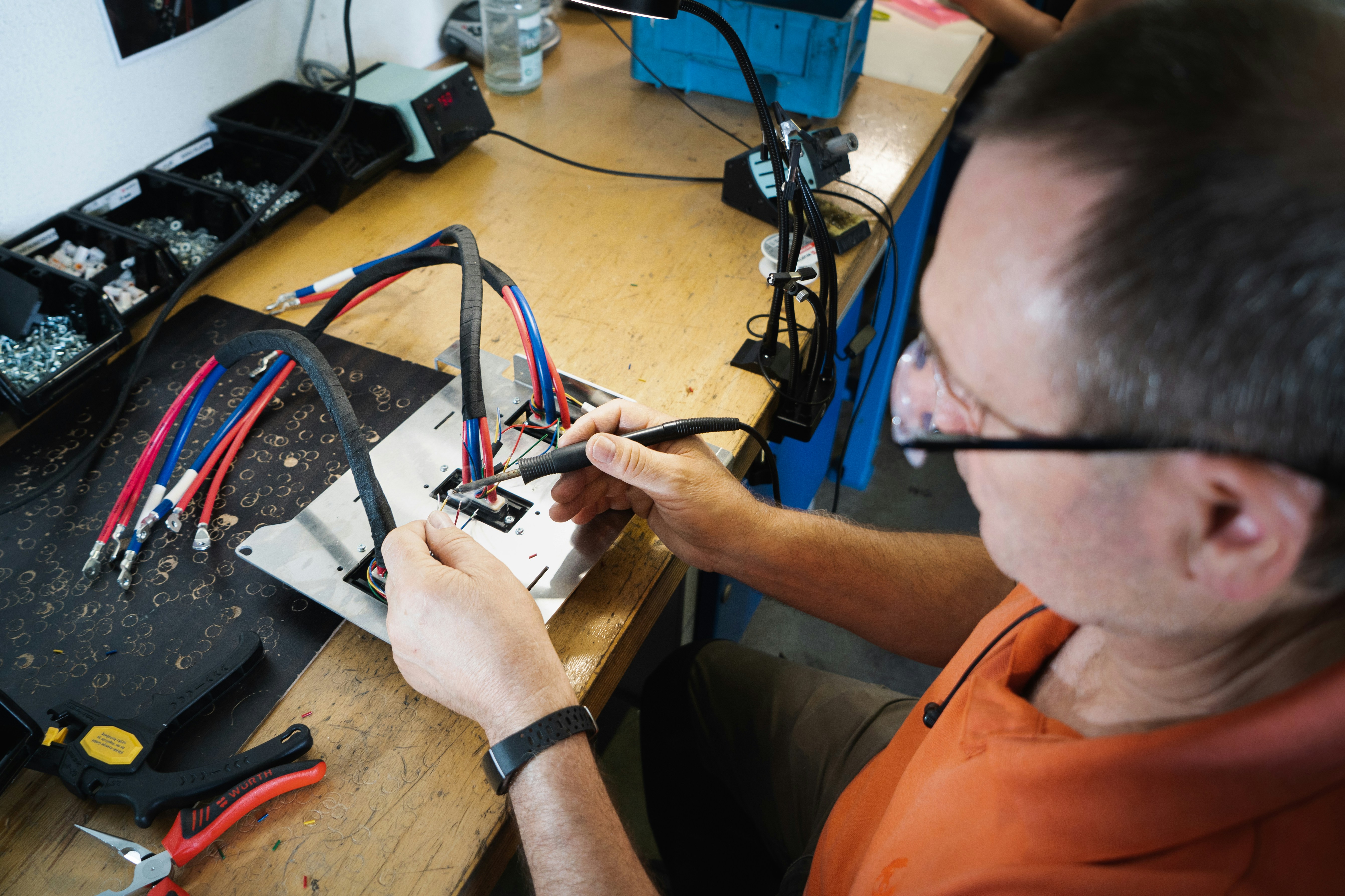Soldering our wire harness for Kumpan electric scooters.