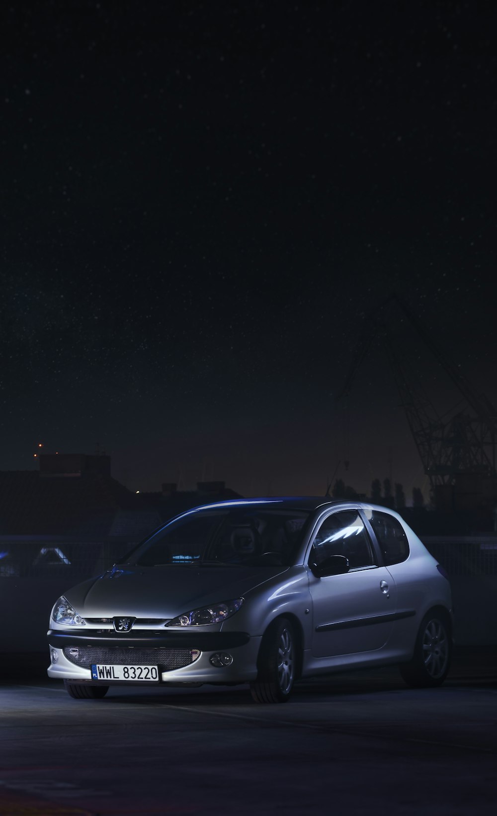 silver sedan on road during night time