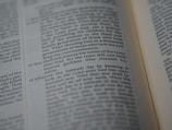 A close-up of an open Bible showing a passage with numbered verses. The focus is on verse 11, which discusses the use of the Lord's name. The text appears in two columns with a slight tilt.