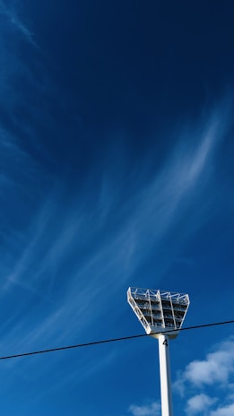 Close-up of the visible battery base of a 7-meter solar lighting tower shining white light.