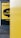 A close-up view of a public advertisement with a yellow background, partially obscured by a yellow object in the foreground. The words 'Ask R U OK?' are visible inside a speech bubble design. Above that, '#stayconnected' is written, and at the bottom, 'ruok.org' is printed.