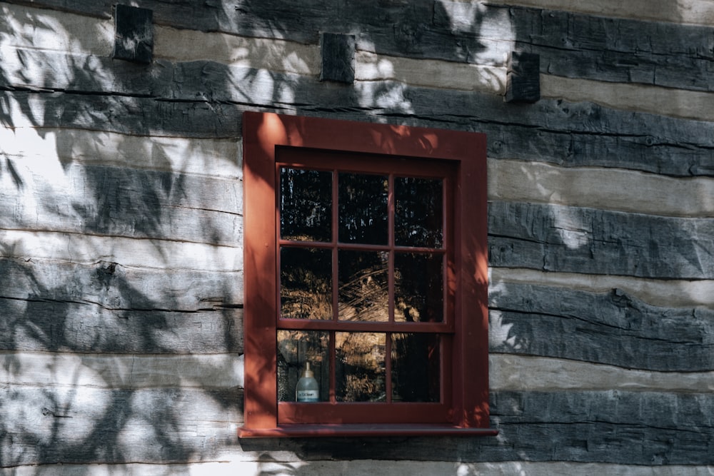 red wooden framed glass window