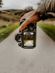 person holding black dslr camera