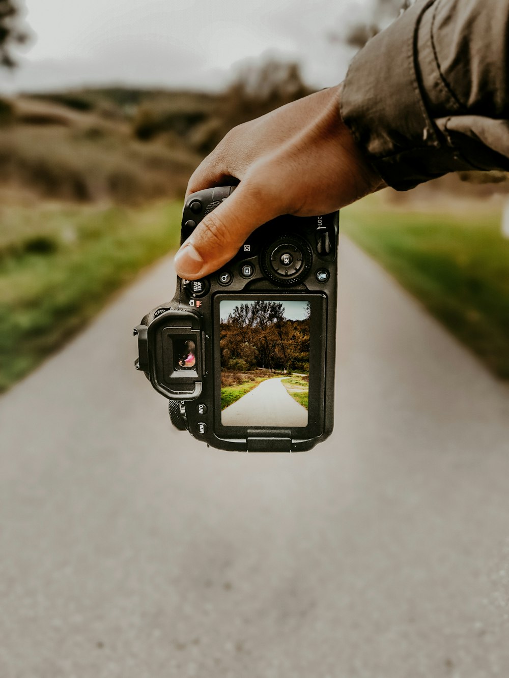 person holding black dslr camera