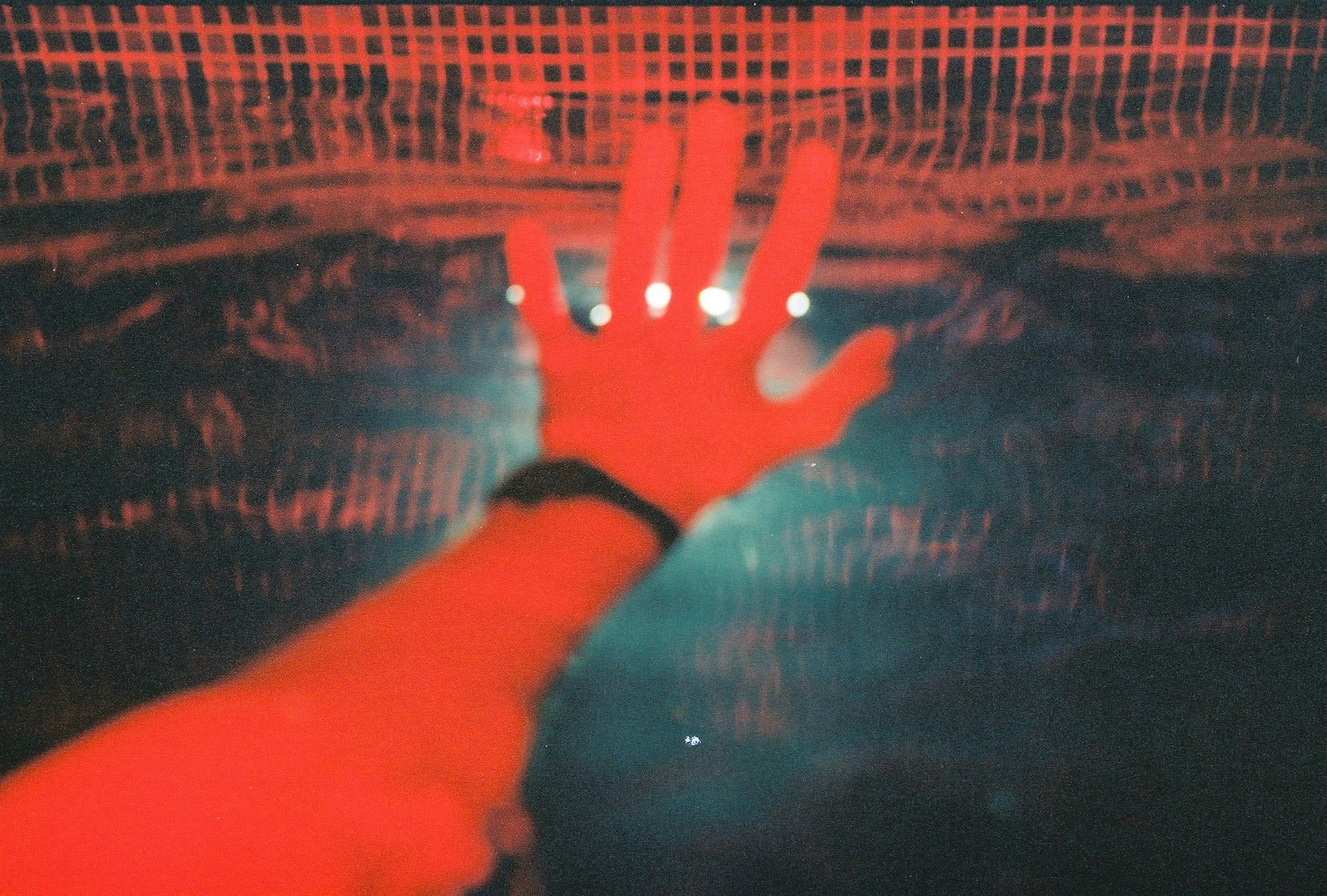 persons hand on black and brown textile