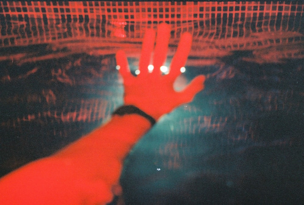 persons hand on black and brown textile