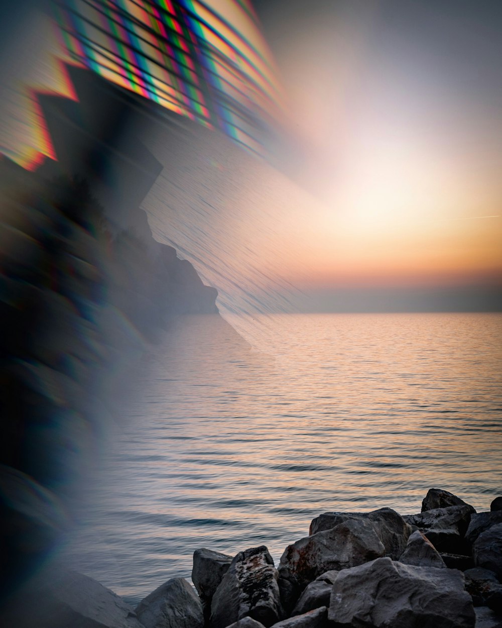 body of water near rocks during daytime