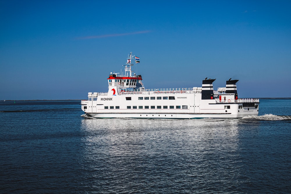 white ship on sea under blue sky during daytime