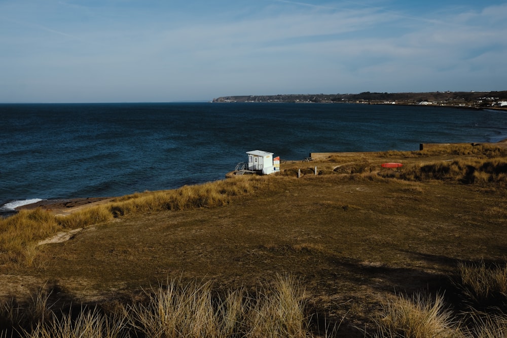 white and brown house near body of water during daytime