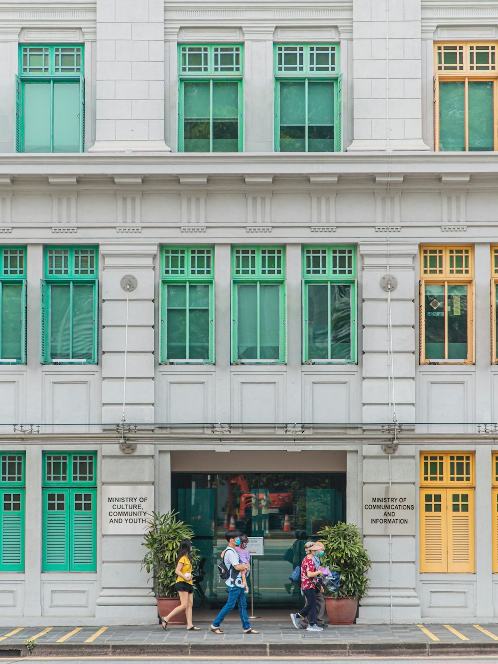 people in front of white concrete building during daytime