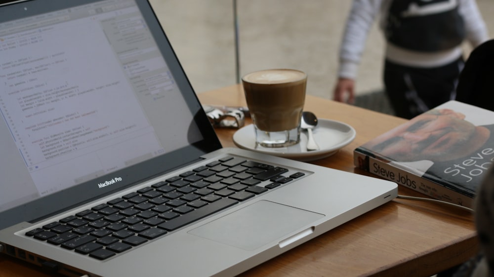 macbook pro on brown wooden table