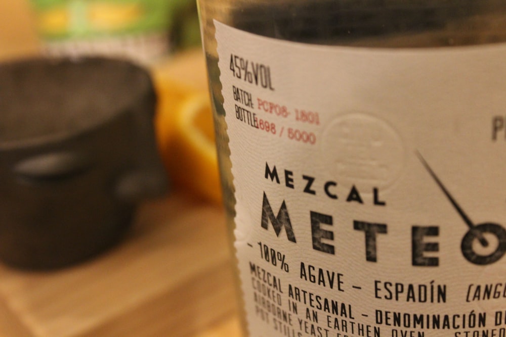 white labeled bottle on brown wooden table