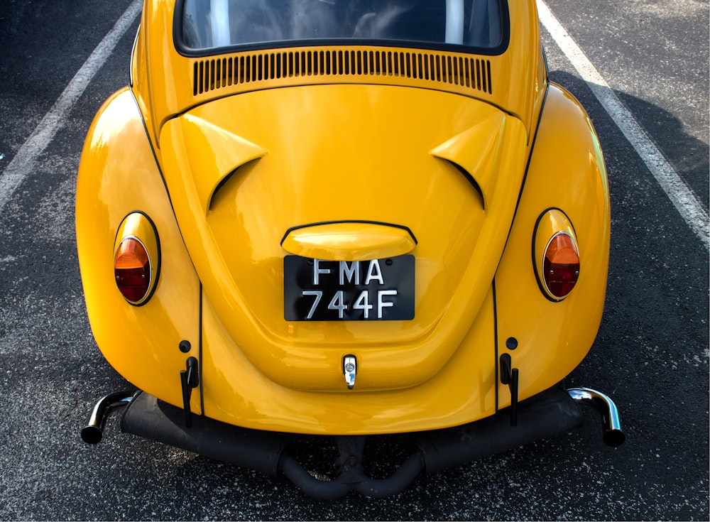 yellow volkswagen beetle on road during daytime