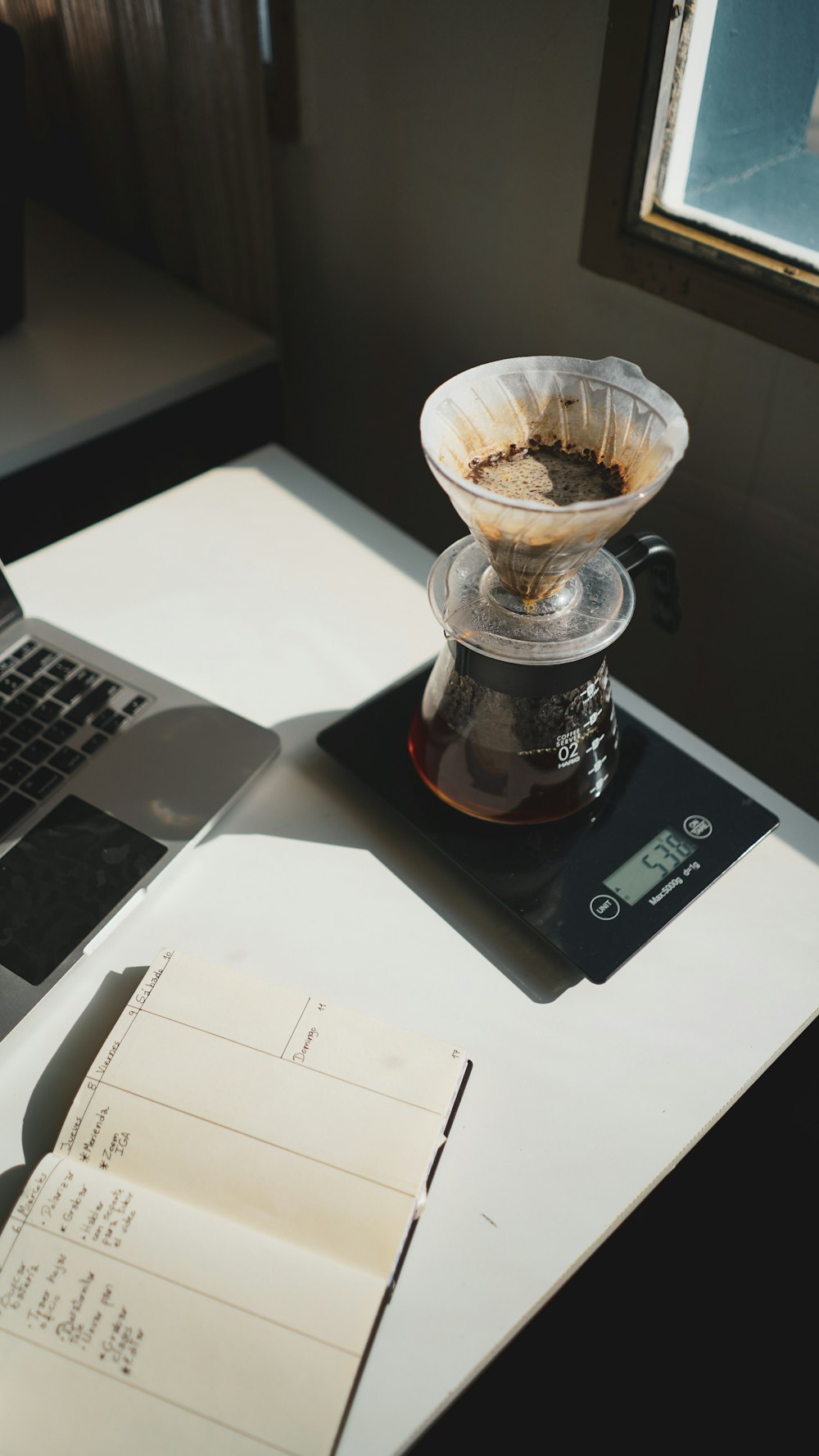 clear glass mug on black and silver laptop computer