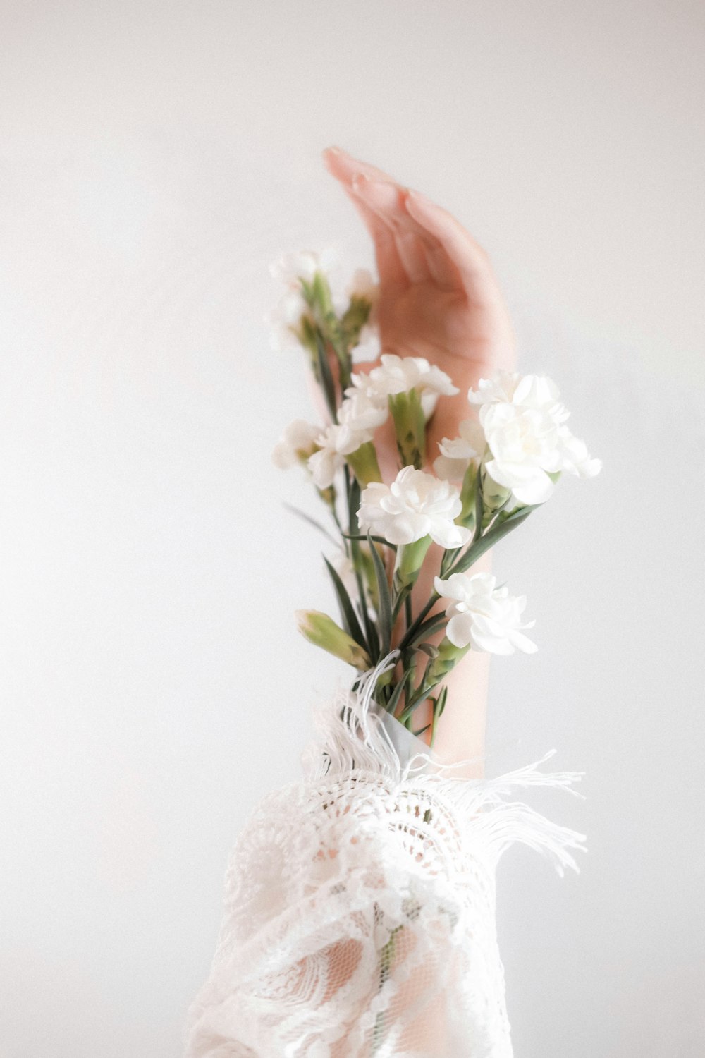 white flowers in white ceramic vase