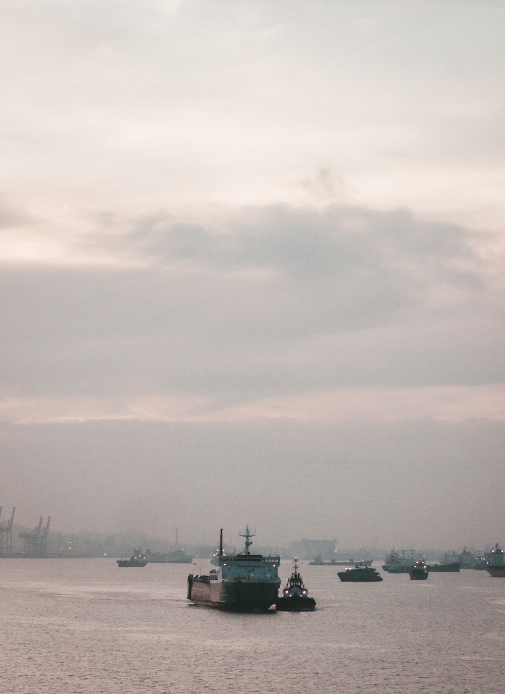 white and black ship on sea under white clouds during daytime