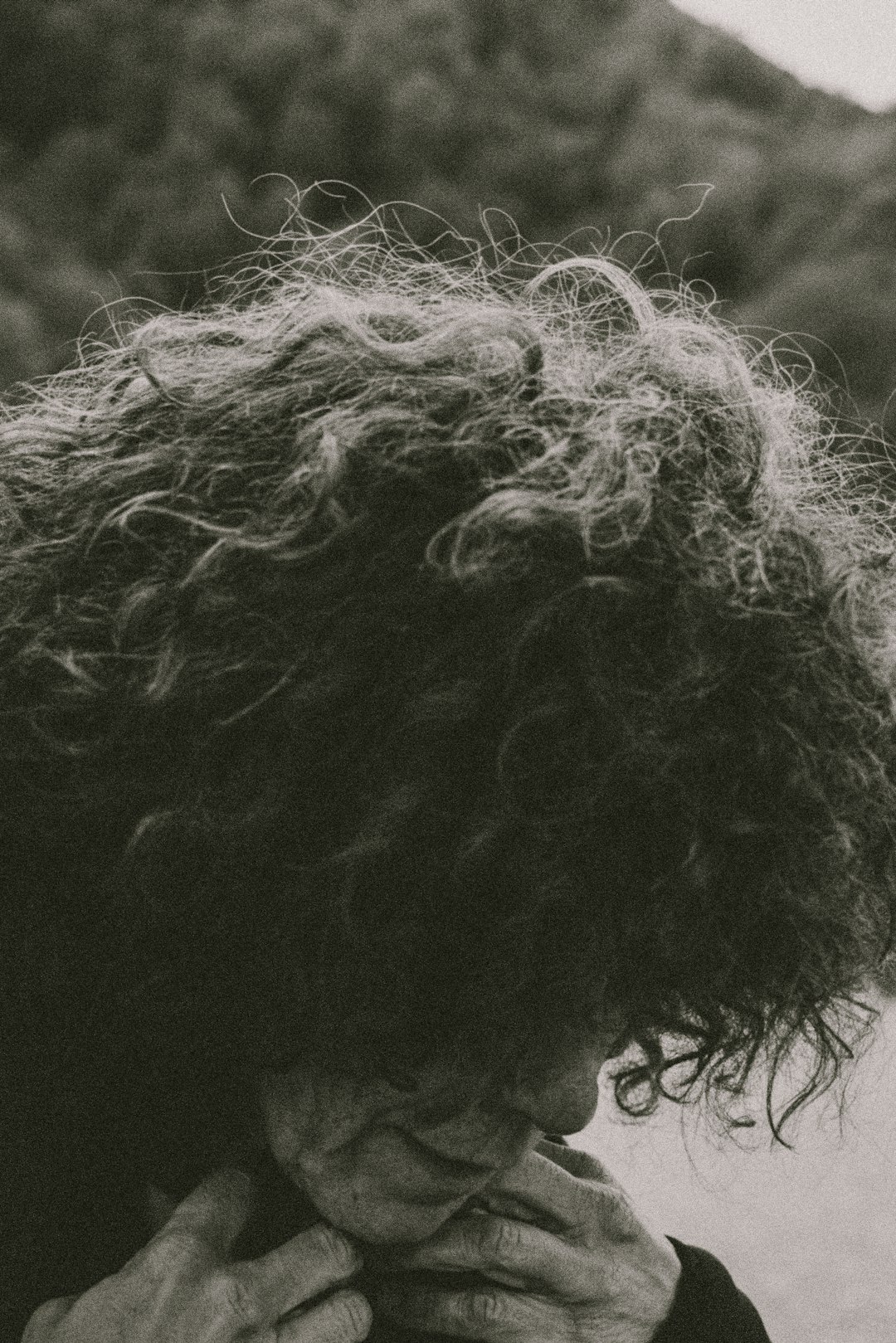 person with black hair in grayscale photography