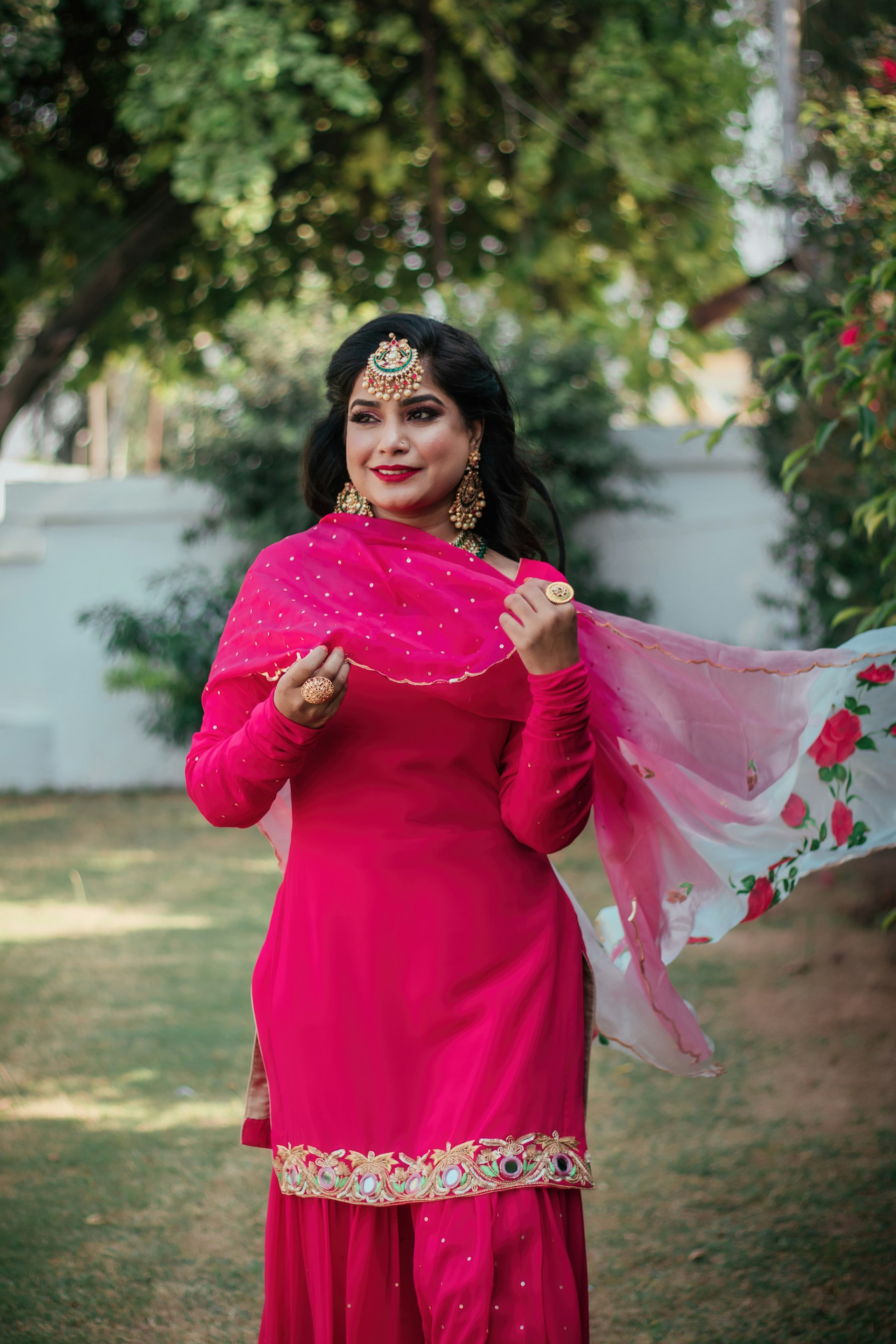 woman in pink long sleeve dress wearing black hijab