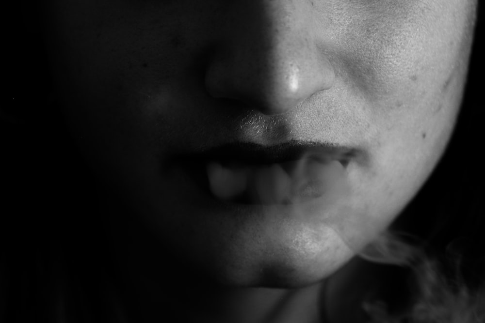 grayscale photo of womans face