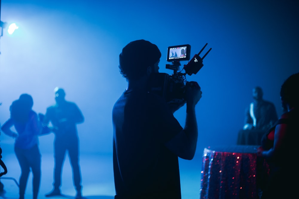 silhouette of man holding camera