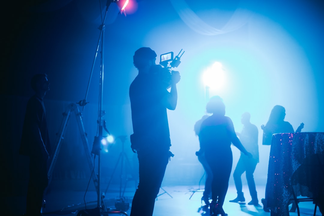 silhouette of people standing on stage,