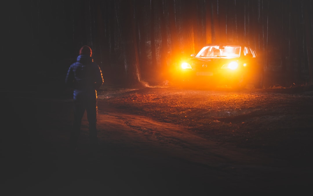 man and woman standing near bonfire during night time