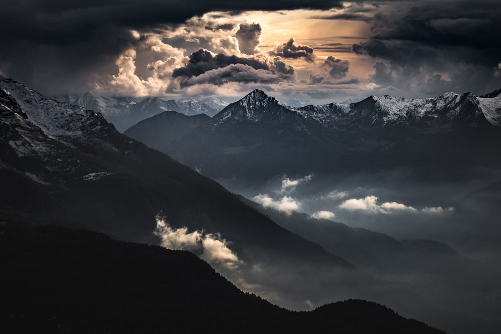 black and white mountains under white clouds during daytime