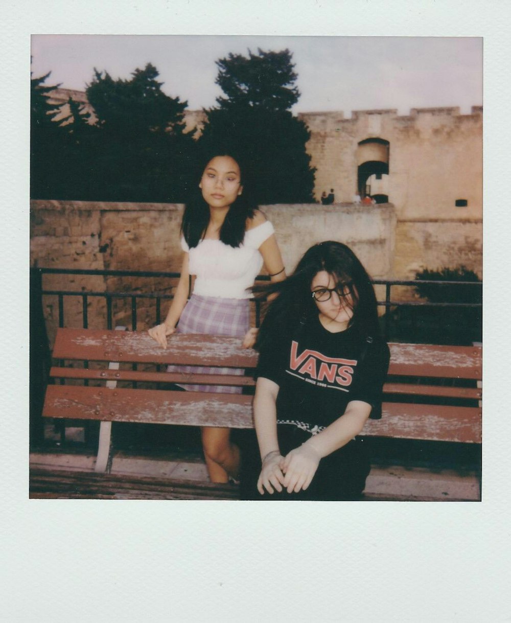 2 women sitting on bench