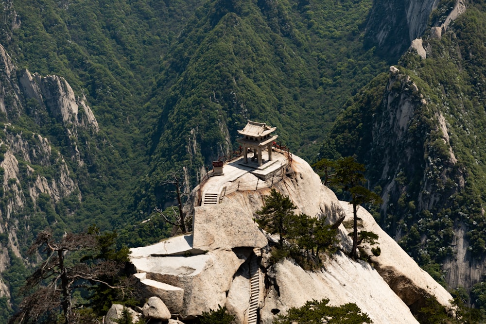 white and brown concrete building on mountain during daytime