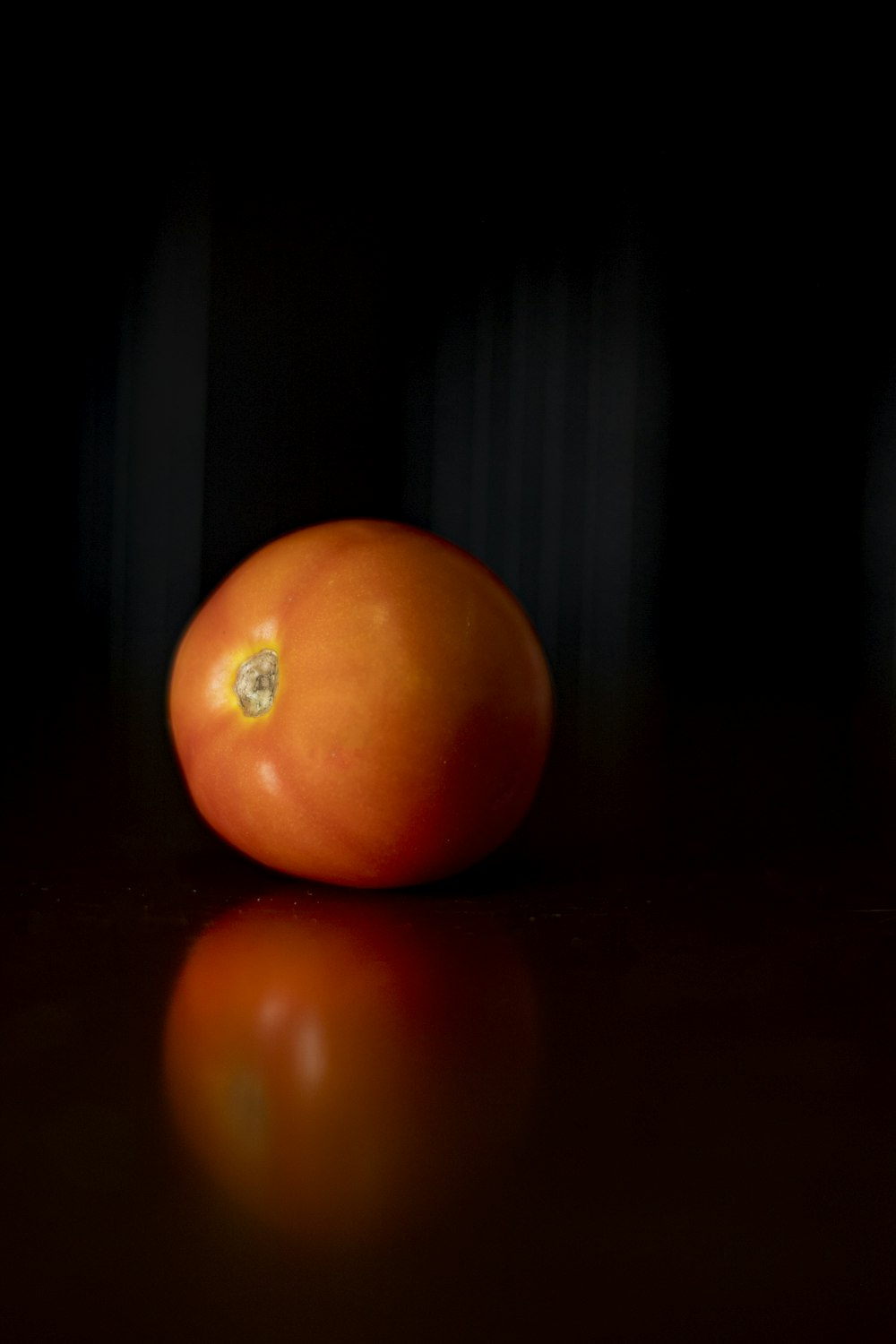 orange tomato on brown wooden table