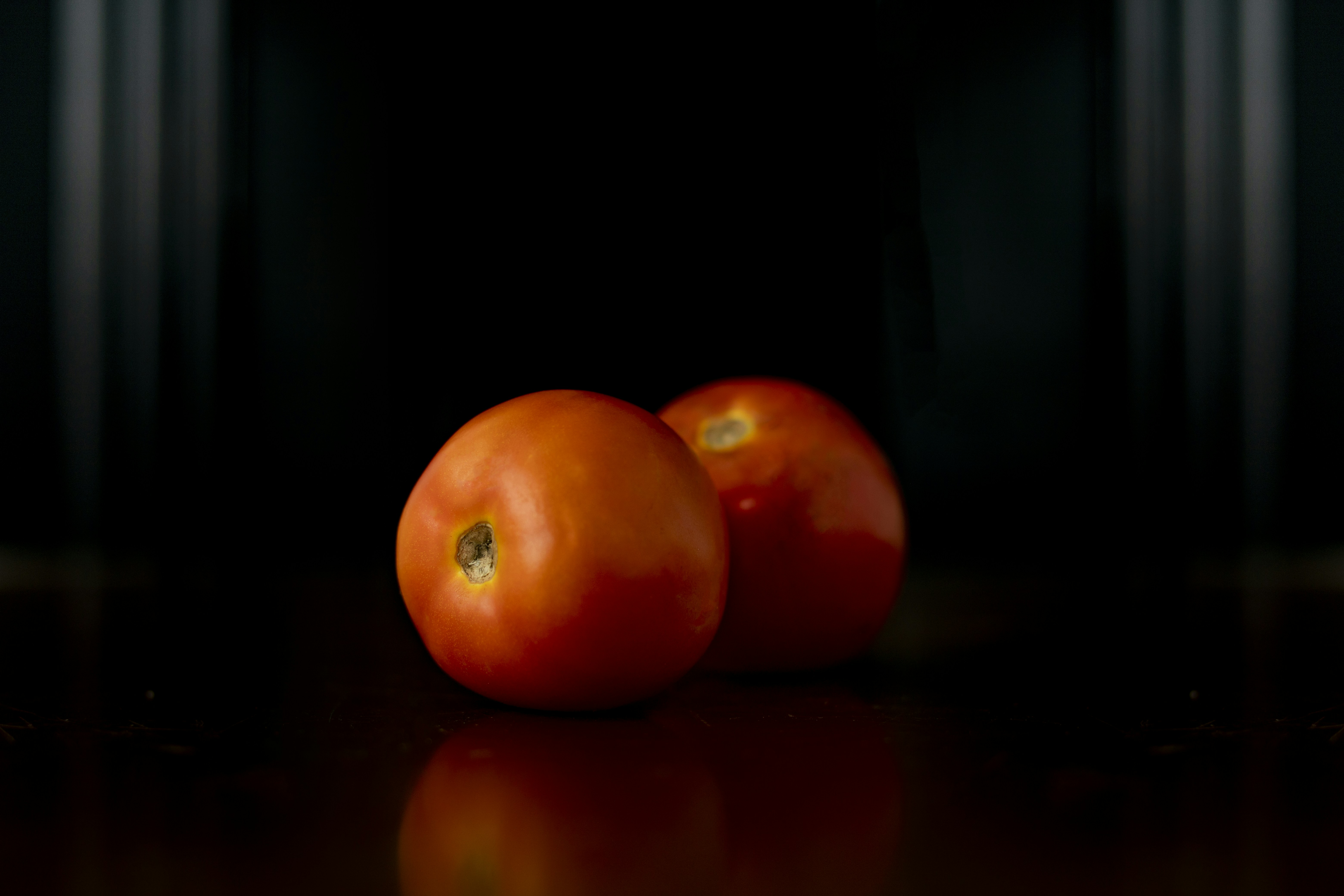 Red tomato on brown wooden table
