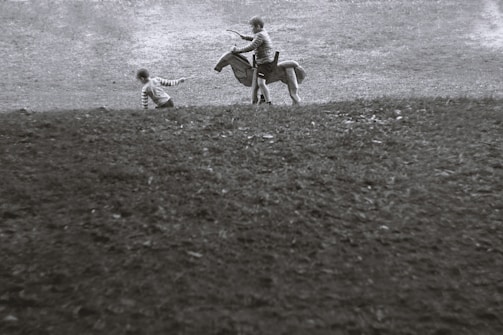 Children engaging in therapeutic horseback riding surrounded by nature