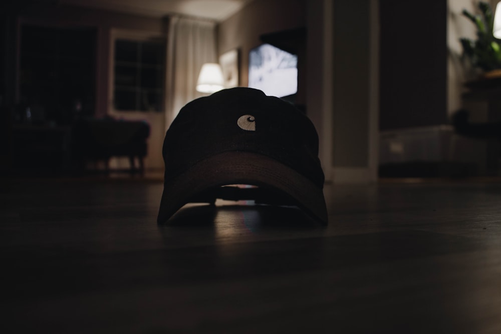 black and brown cap on brown wooden table