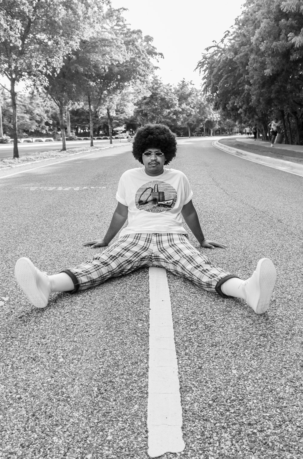 woman in white shirt sitting on road