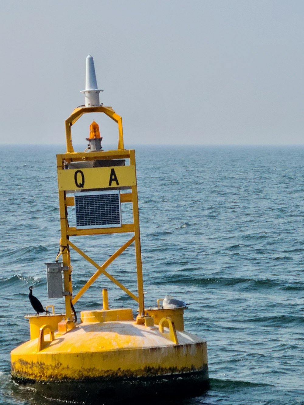 yellow and black watch tower on yellow and white boat on sea during daytime