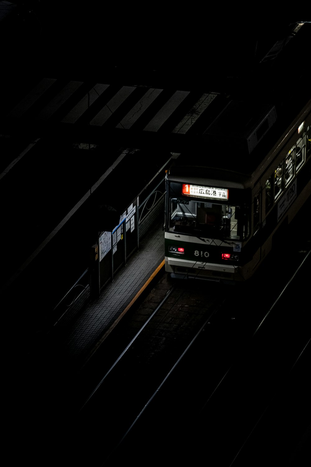 white and black bus on road during night time