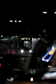 Night view of a tram system illuminated by subtle blue and steel gray lighting.