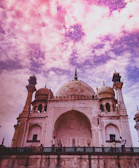 Sunrise over the Taj Mahal with vibrant orange and pink skies.