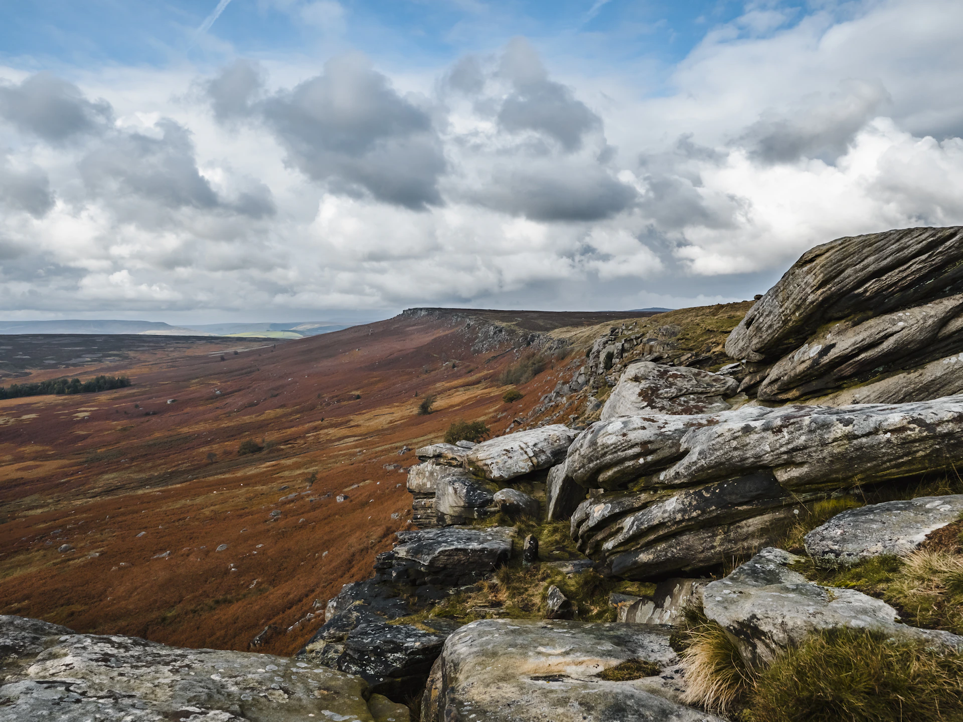 brown and gray rocky mountain under white clouds and blue sky during daytime