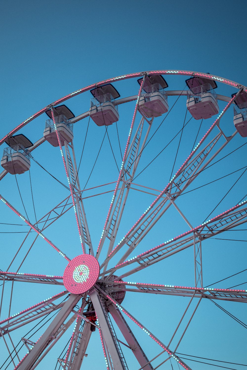 red and white ferris wheel under blue sky during daytime