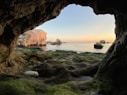 brown rock formation on sea during daytime