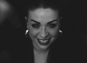 A busy person smiling while quickly using mono, ready for a night out.