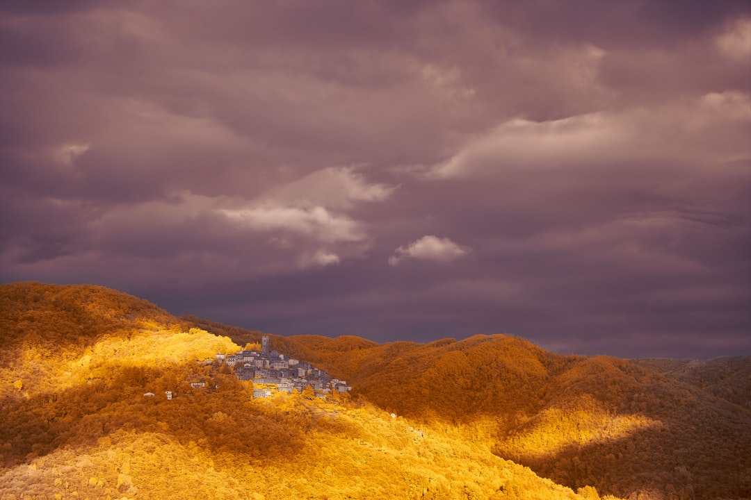 brown and green mountain under cloudy sky during daytime