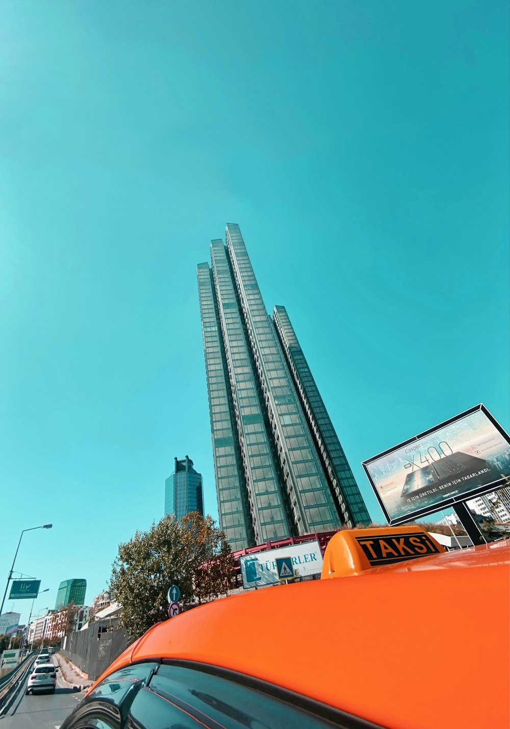 orange car near brown building during daytime