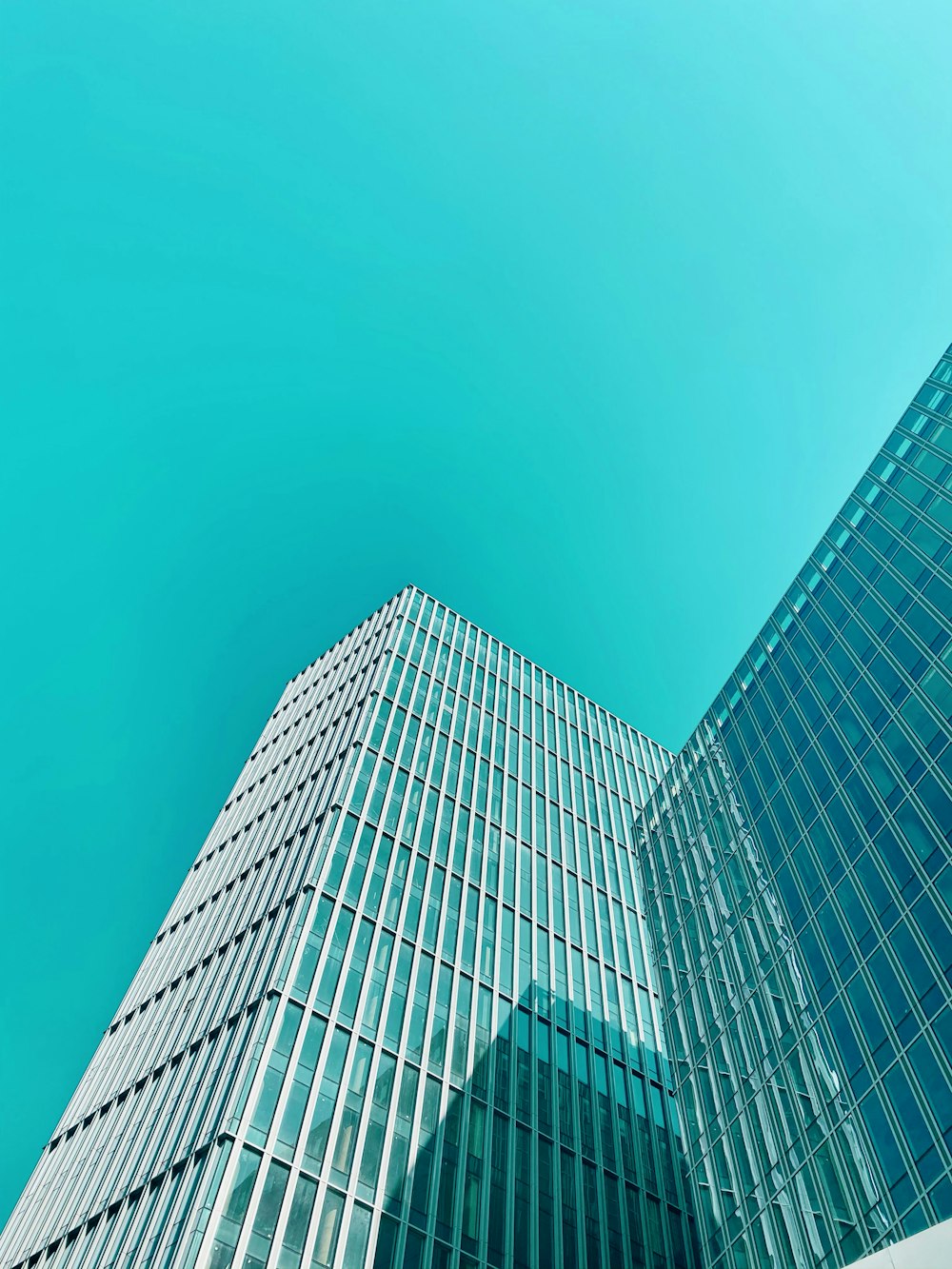 blue glass walled high rise building