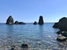 black rock formation on blue sea under blue sky during daytime