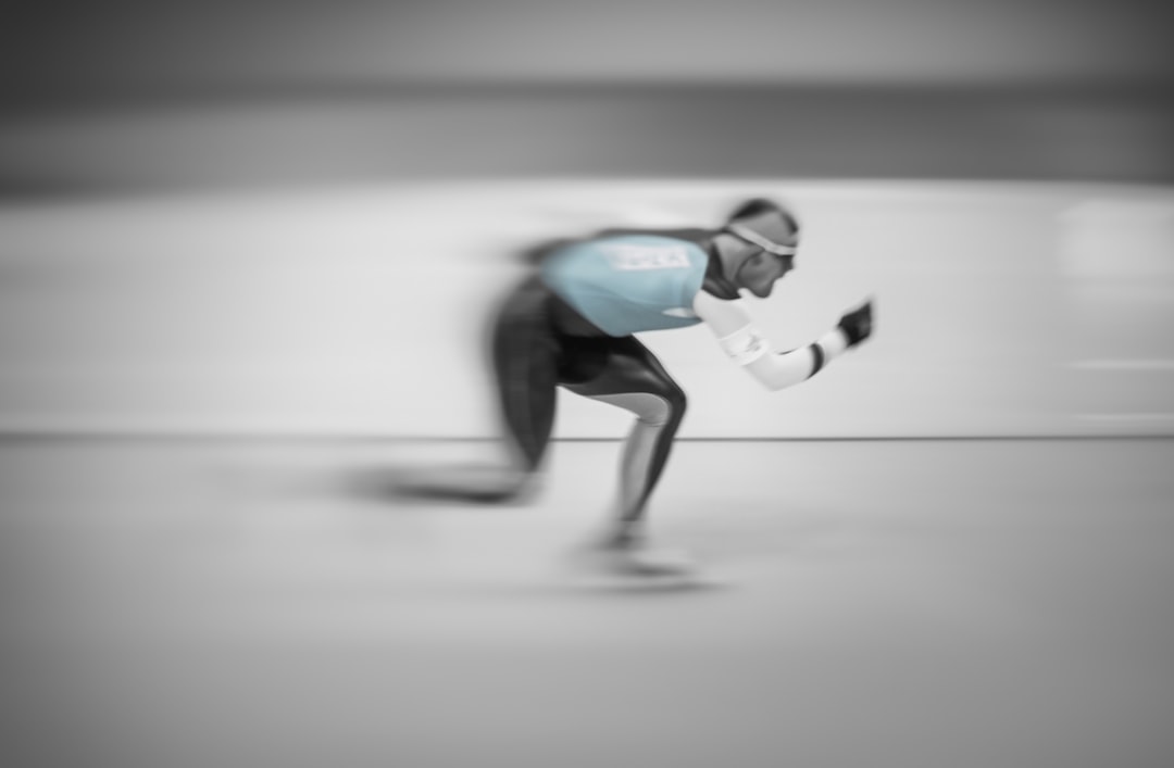 man in blue shirt and black pants doing skateboard stunts,