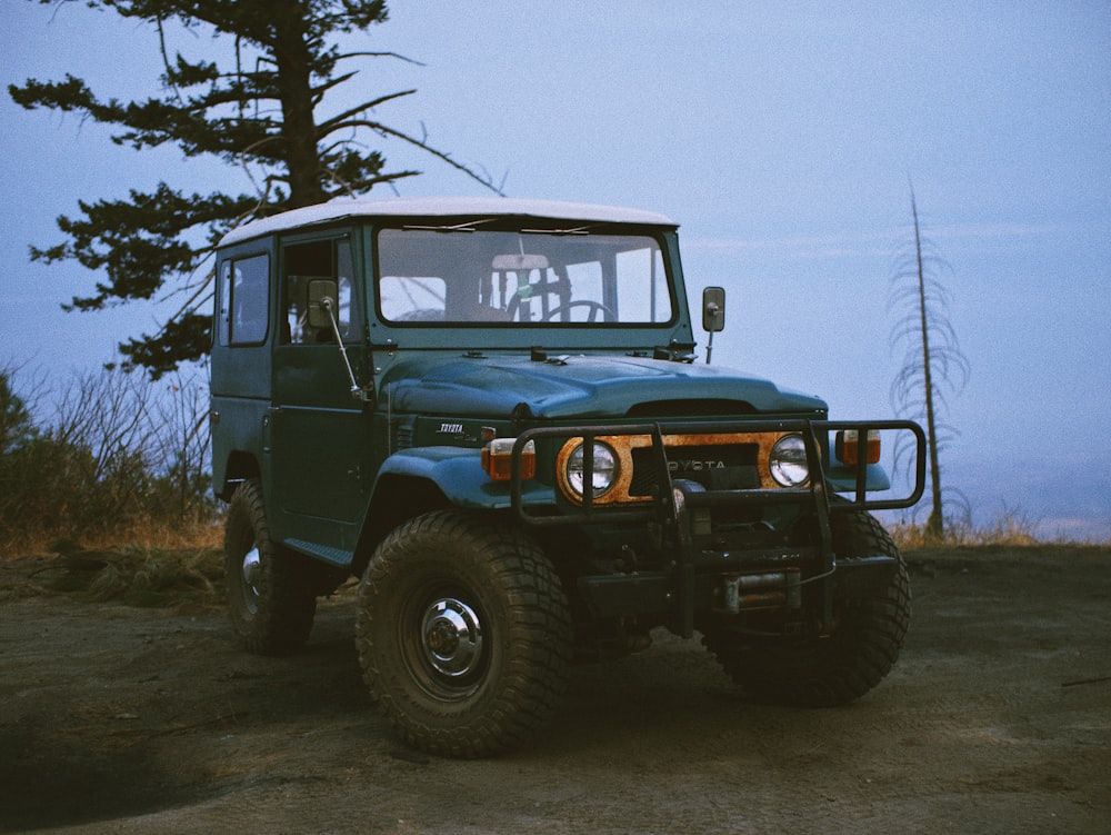 blue and black jeep wrangler on snow covered ground during daytime